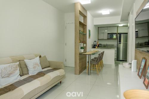 a living room with a couch and a kitchen at In Mare Bali Resort Beira Mar by Qavi - 109 in Parnamirim