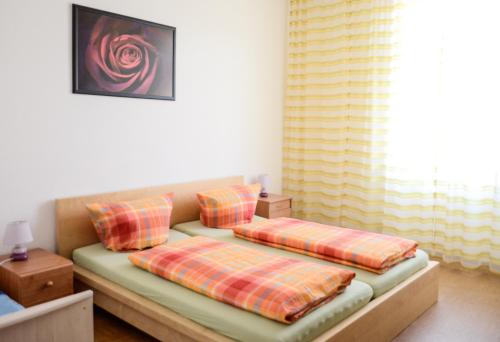 a bed with two pillows on it in a room at Ferienhaus Seerose in Baden-Baden