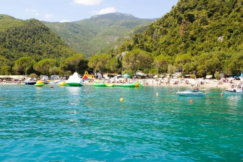 a group of people in the water at a beach at Apartment Medveja 3430b in Medveja