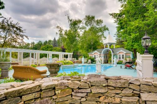 a swimming pool in a yard with a stone wall at Mountain Views Beautiful Nestlenook Farm Home! in Jackson