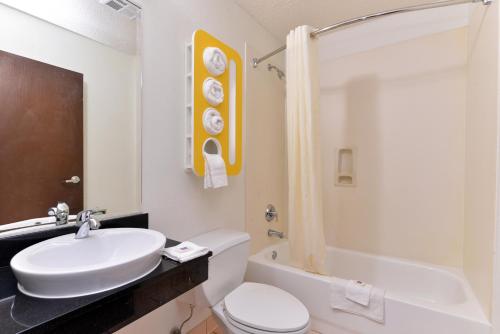 a bathroom with a sink and a toilet and a tub at Motel 6-Richburg, SC in Richburg