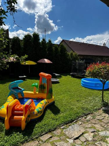 a childs toy train on the grass in a yard at Barinka in Světec