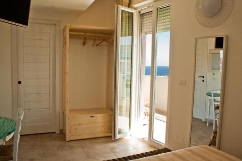 a bedroom with a view of the ocean at B&B Alalama in Polignano a Mare