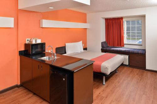 a small hotel room with a bed and a sink at Motel 6-Richburg, SC in Richburg