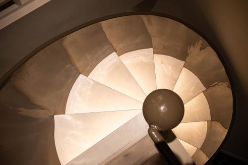 a close up of a spiral staircase with a spoon at Rest Collection RedHouse Melaka in Melaka
