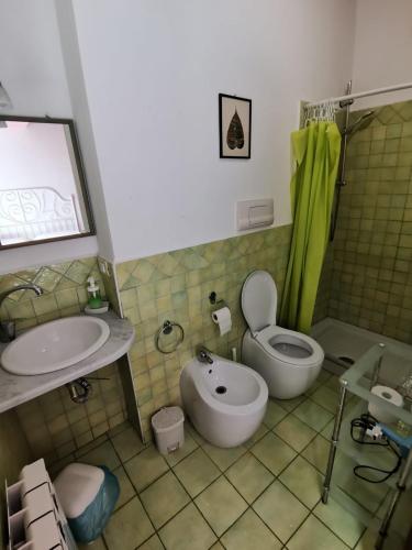 a bathroom with a toilet and a sink at B&B Xenia in Mongiove