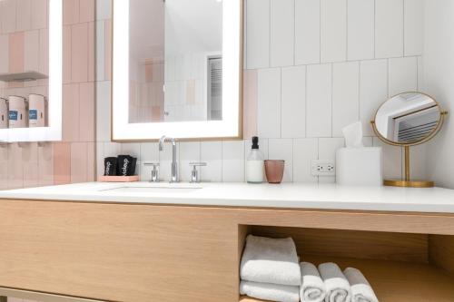 a bathroom with a sink and a counter with towels at The Doyle Hotel in Charlottesville