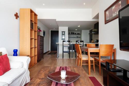 a living room with a white couch and a table at Beautiful apartment w/amenities in front of CARSO in Mexico City