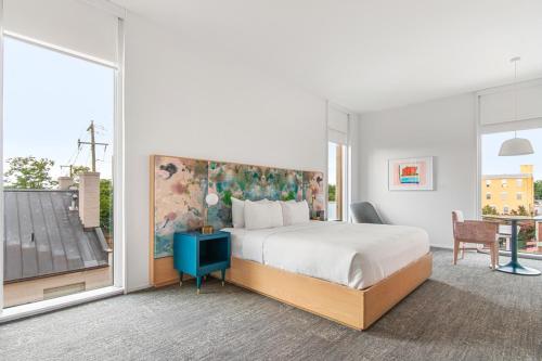 a hotel room with a bed and a balcony at The Doyle Hotel in Charlottesville