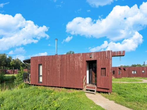 a small red building on top of a field at Peaceful Bungalow Escape in Antoing