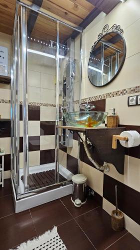 a bathroom with a glass shower with a sink at Cobijo de Villar in Carrocera