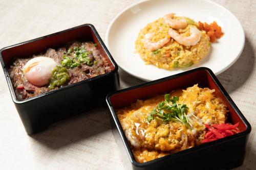 three trays of food on a table with a plate of food at ホテル ブルジュア 久留米 Hotel Bvljua -レジャーホテル- in Kurume