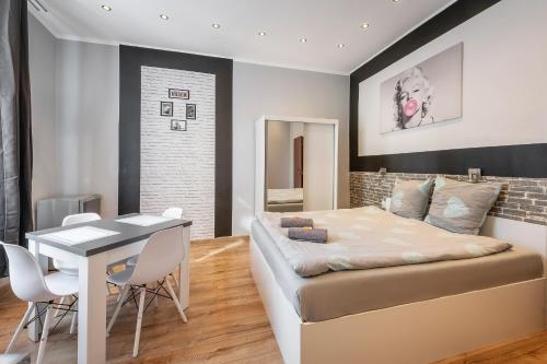 a bedroom with a bed and a table and chairs at 70s Guest room in Kraków