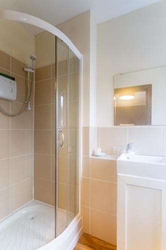 a bathroom with a shower and a sink at Lamlash Bay Hotel in Lamlash