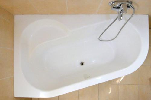 a white bath tub in a bathroom at Domik by the sea in Haifa