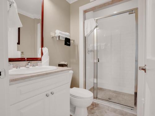 a bathroom with a toilet and a sink and a shower at Valentines Resort & Marina in Harbour Island