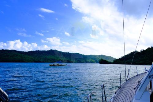 a boat on a large body of water at PICO DE LORO Nearest to Pool JACANA 1 Bedroom Units by SEE Condominiums in Cutad