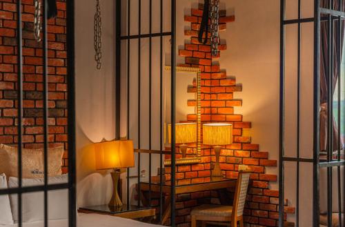 a room with a table and a brick wall at Regale Motel in Zhonghe
