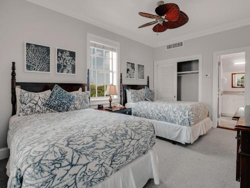a bedroom with two beds and a ceiling fan at Valentines Resort & Marina in Harbour Island