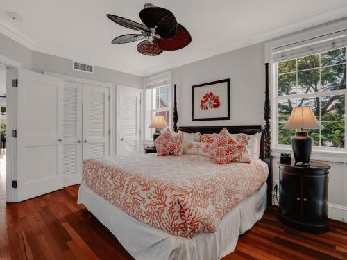 a bedroom with a bed and a ceiling fan at Valentines Resort & Marina in Harbour Island