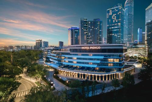 a hotel indigo singapore in front of a city at Hotel Indigo Suzhou Jinji Lake by IHG in Suzhou