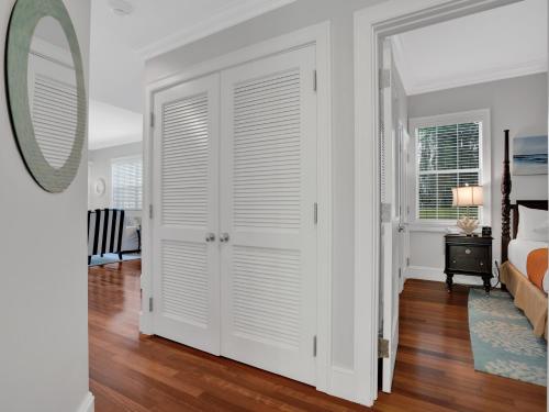 a white door in a room with a bed and a mirror at Valentines Resort & Marina in Harbour Island