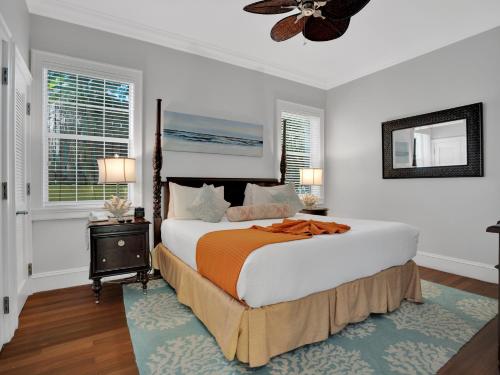 a bedroom with a large bed with an orange blanket at Valentines Resort & Marina in Harbour Island