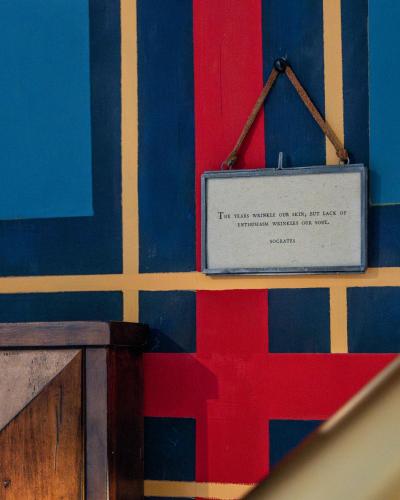 a sign on a wall with blue and red stripes at Twin Gables of Woodstock in Woodstock