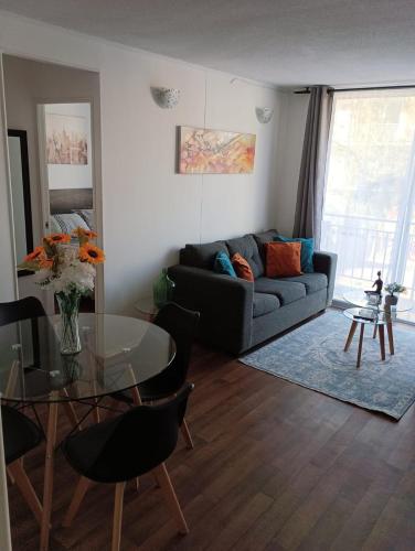 a living room with a couch and a glass table at 202 Mitimae in Ovalle