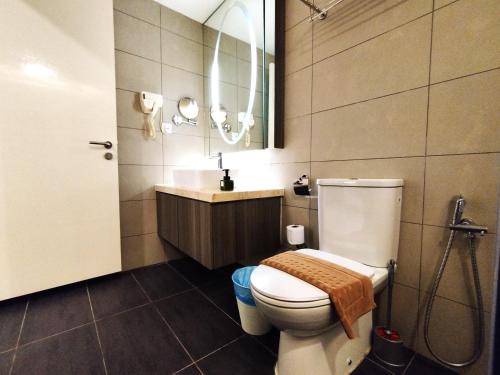 a bathroom with a toilet and a sink and a mirror at Genting GetawayStayCationHut AT Ion Delemen in Genting Highlands