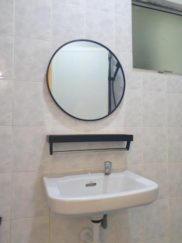 a bathroom with a sink and a mirror on the wall at Sri Raya Apartment Bandar Baru Bangi in Kajang