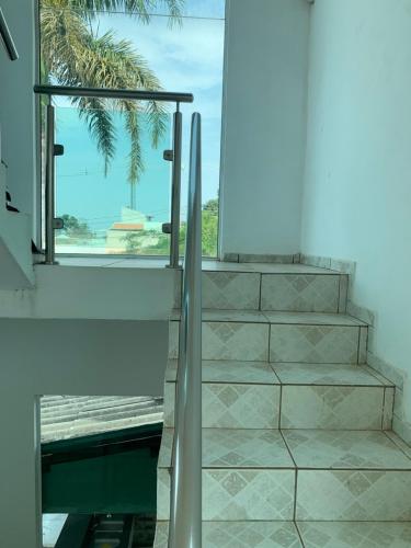 a set of stairs with a view of a palm tree at Casa Branca in Londrina