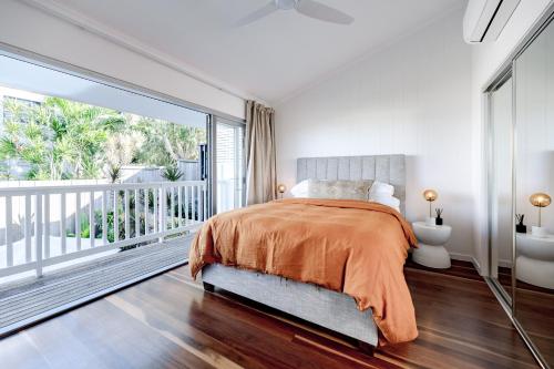a bedroom with a bed and a balcony at 'La Palma', Sunshines Heart beside The Village in Sunshine Beach