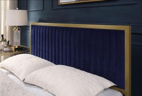 a blue bedroom with a bed with a blue headboard at Richmond Hill Guesthouse- Serviced Condo in Gqeberha