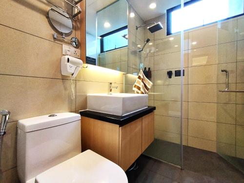 a bathroom with a toilet and a sink and a shower at Genting FreezingColdInn2R1B AT Ion Delemen in Genting Highlands