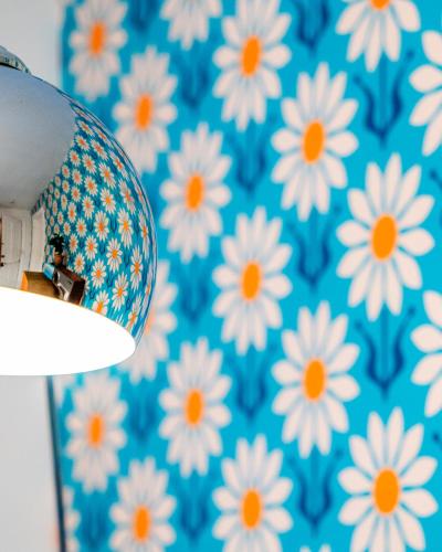 a blue and white wallpaper with white flowers on it at Twin Gables of Woodstock in Woodstock