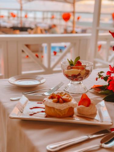 a table with a plate of food and a bowl of fruit at Valentines Resort & Marina in Harbour Island