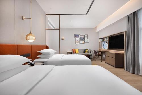 Ένα ή περισσότερα κρεβάτια σε δωμάτιο στο Home2 Suite by Hilton Hengyang Xidu