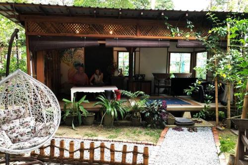 a house with two people standing in the living room at Tirtha Quddus Farm Stay in Kampong Sum Sum
