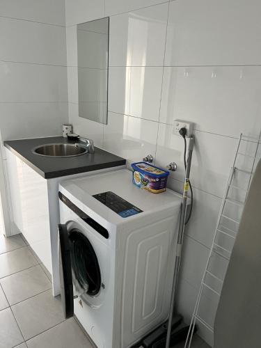 a washing machine in a kitchen next to a sink at Albatross Motor Inn in Lakes Entrance