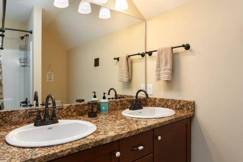 two sinks in a bathroom with a large mirror at River Rock Cabin - Comfortable, Private Home with King Beds & Mountain Views in Horse Shoe