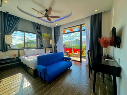 a hotel room with a bed and a blue chair at The Night Market Villa 1 - Near Hoi An Old Town 200m in Hoi An