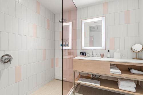a bathroom with a sink and a mirror at The Doyle Hotel in Charlottesville