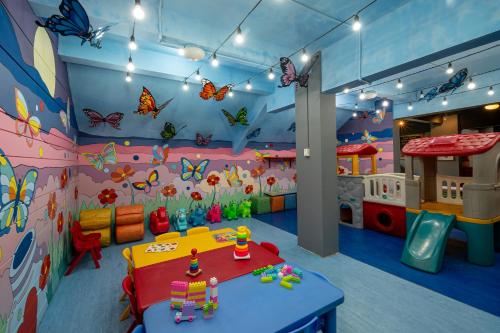 a childs play room with butterflies on the walls at Prime Plaza Suites Sanur – Bali in Sanur