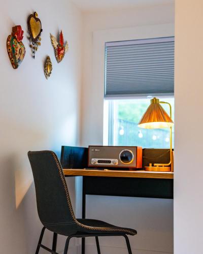 a desk with a radio and a window with butterfly magnets at Twin Gables of Woodstock in Woodstock