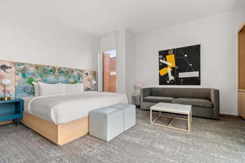 a bedroom with a large bed and a couch at The Doyle Hotel in Charlottesville