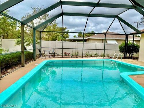 a swimming pool with a pergola over it at Beautiful 3 Bed House with pool in North Fort Myers