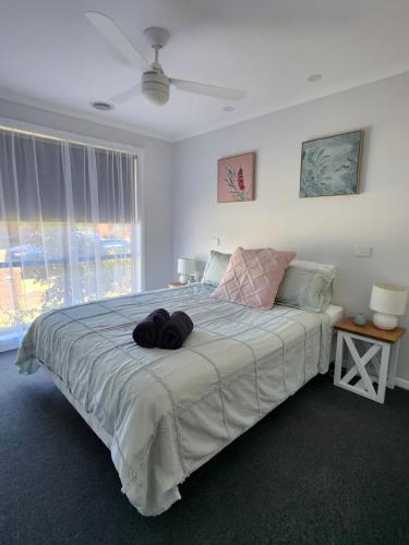 a bedroom with a large bed with a large window at Lbarza Charming & Convenient 3BR Home close to Hospitals & Sporting Grounds in Shepparton