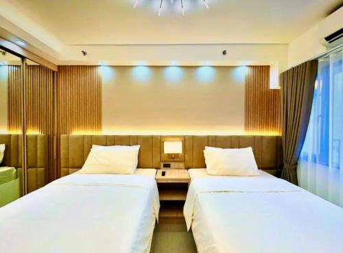 Ліжко або ліжка в номері Hotel-Like Staycation2 MOA Pasay