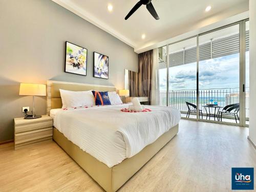 a bedroom with a large bed and a balcony at Encorp Marina Puteri Harbour by RR JBcity in Nusajaya